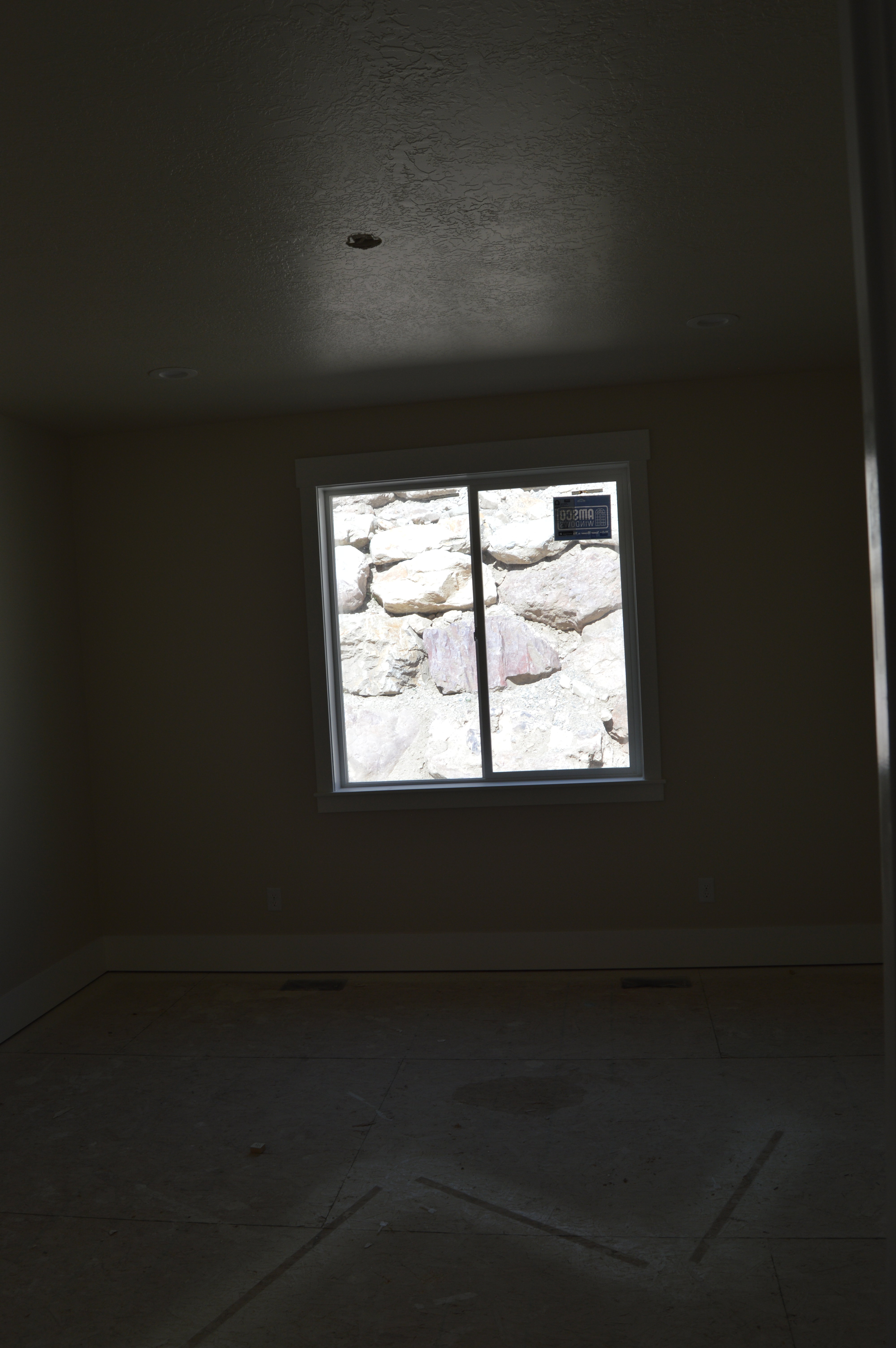 Spare room featuring baseboards and a textured ceiling