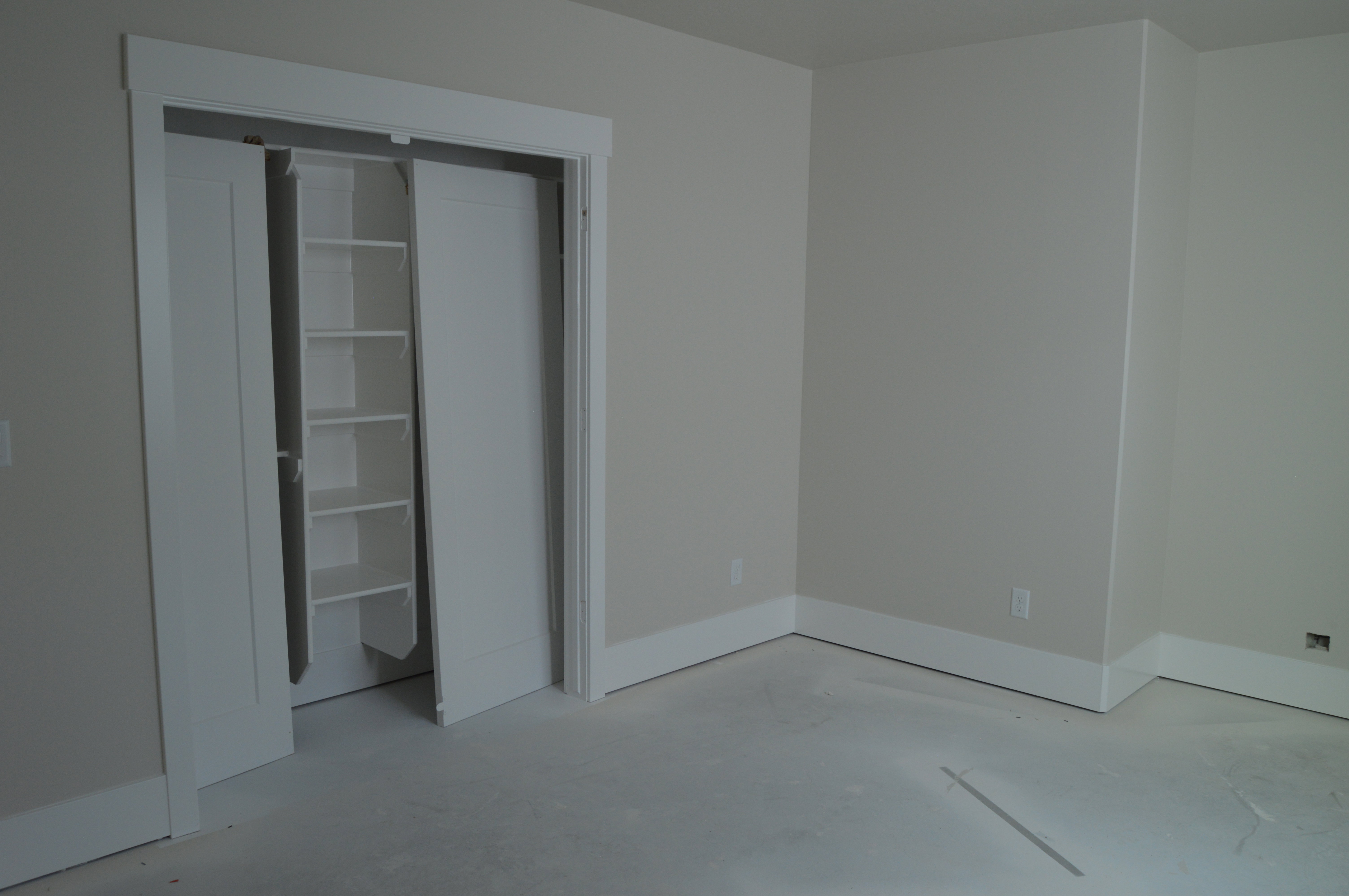 Unfurnished bedroom featuring concrete flooring and a closet