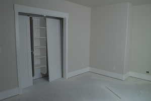 Unfurnished bedroom featuring concrete flooring and a closet