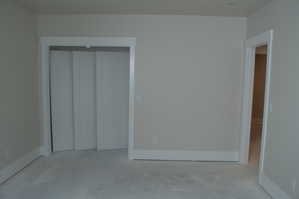 Unfurnished bedroom featuring a closet and unfinished concrete flooring