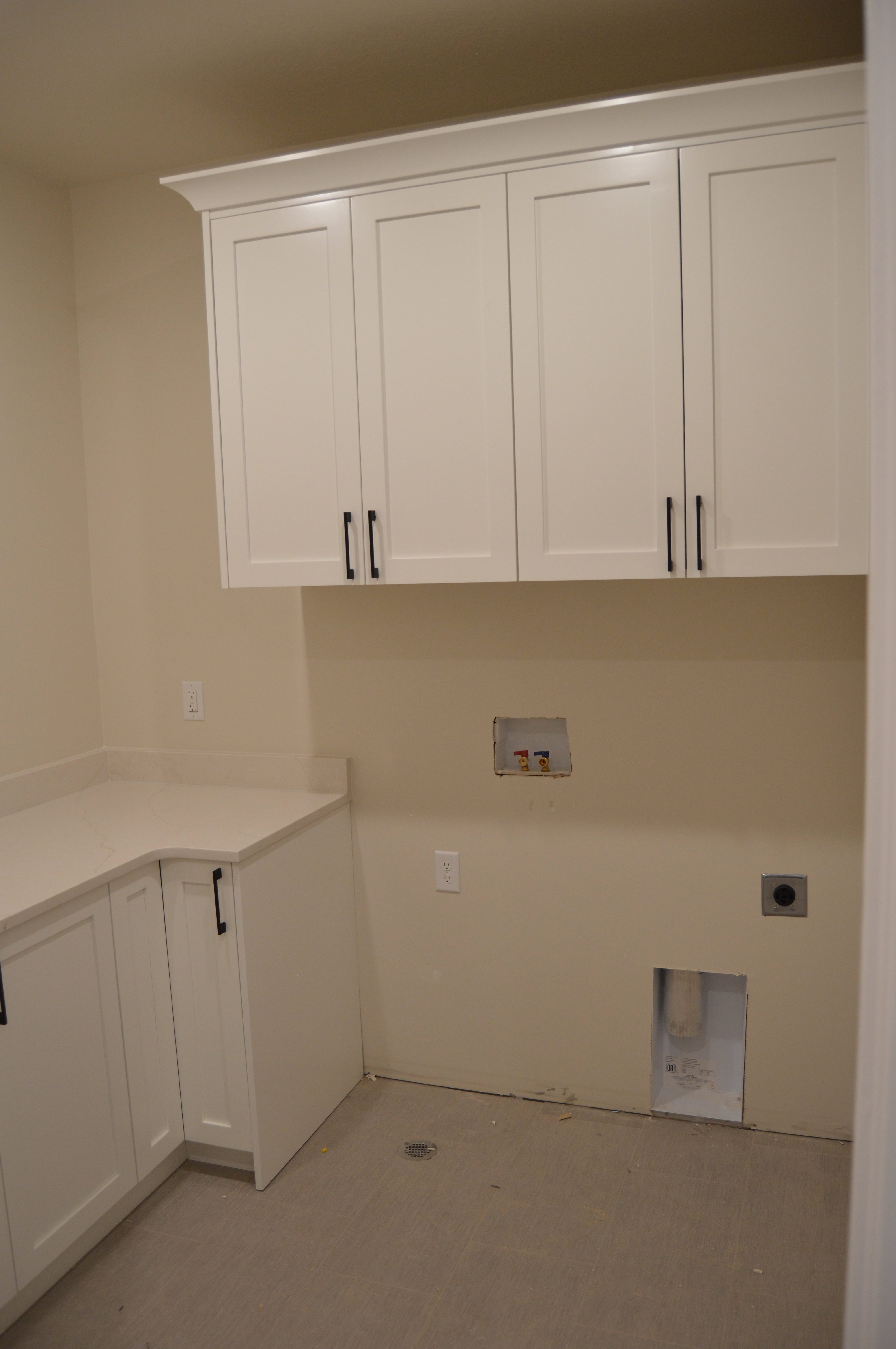 Laundry area with cabinet space, hookup for a washing machine, and hookup for an electric dryer