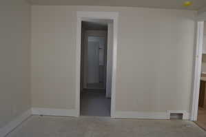 Empty room featuring baseboards