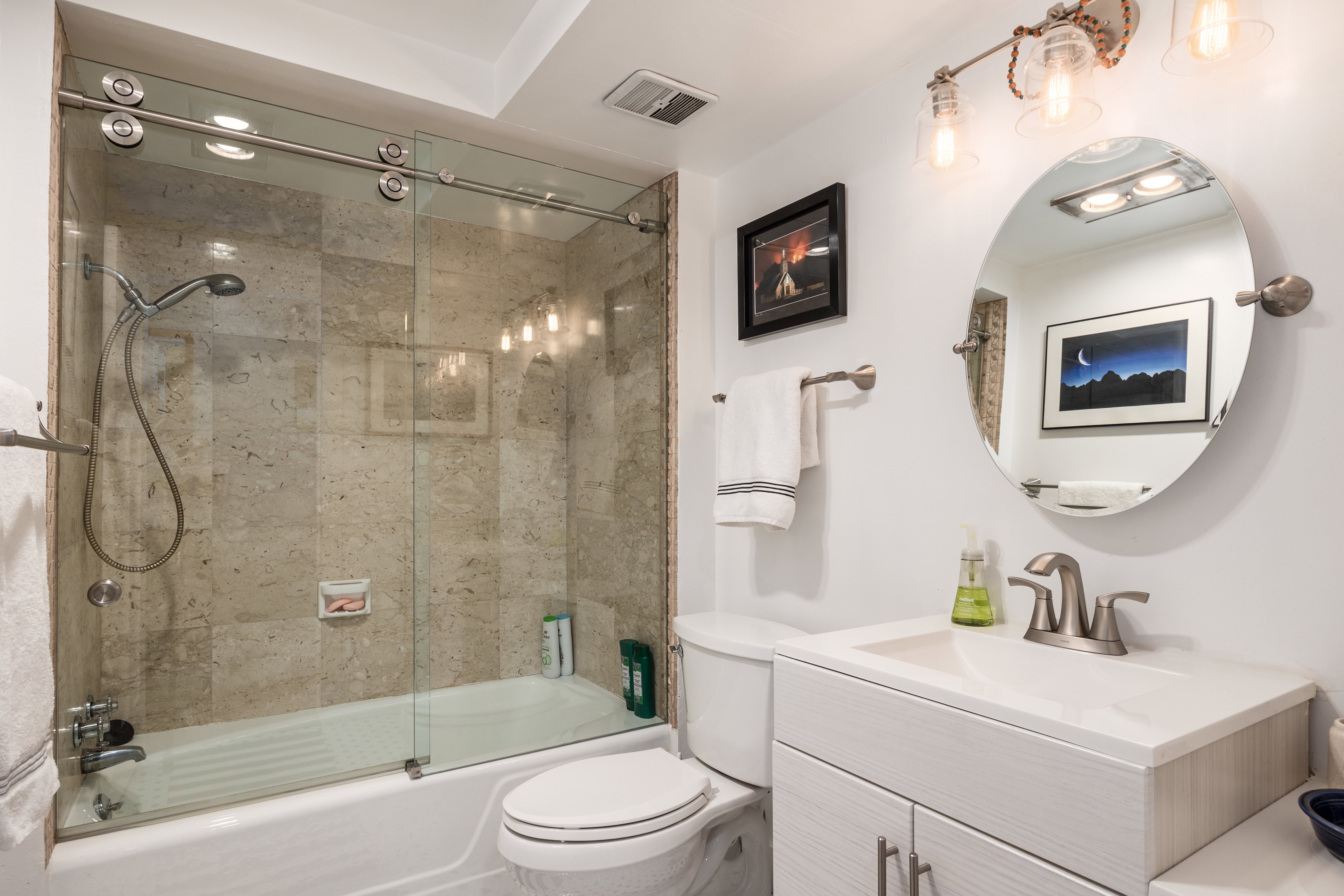 Full bath featuring vanity and combined bath / shower with glass door