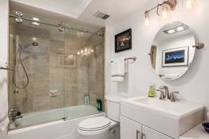Full bath featuring vanity and combined bath / shower with glass door