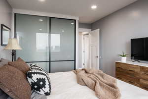 Bedroom featuring recessed lighting and a closet