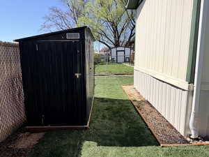 View of shed featuring a fenced backyard