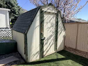 View of shed with a fenced backyard