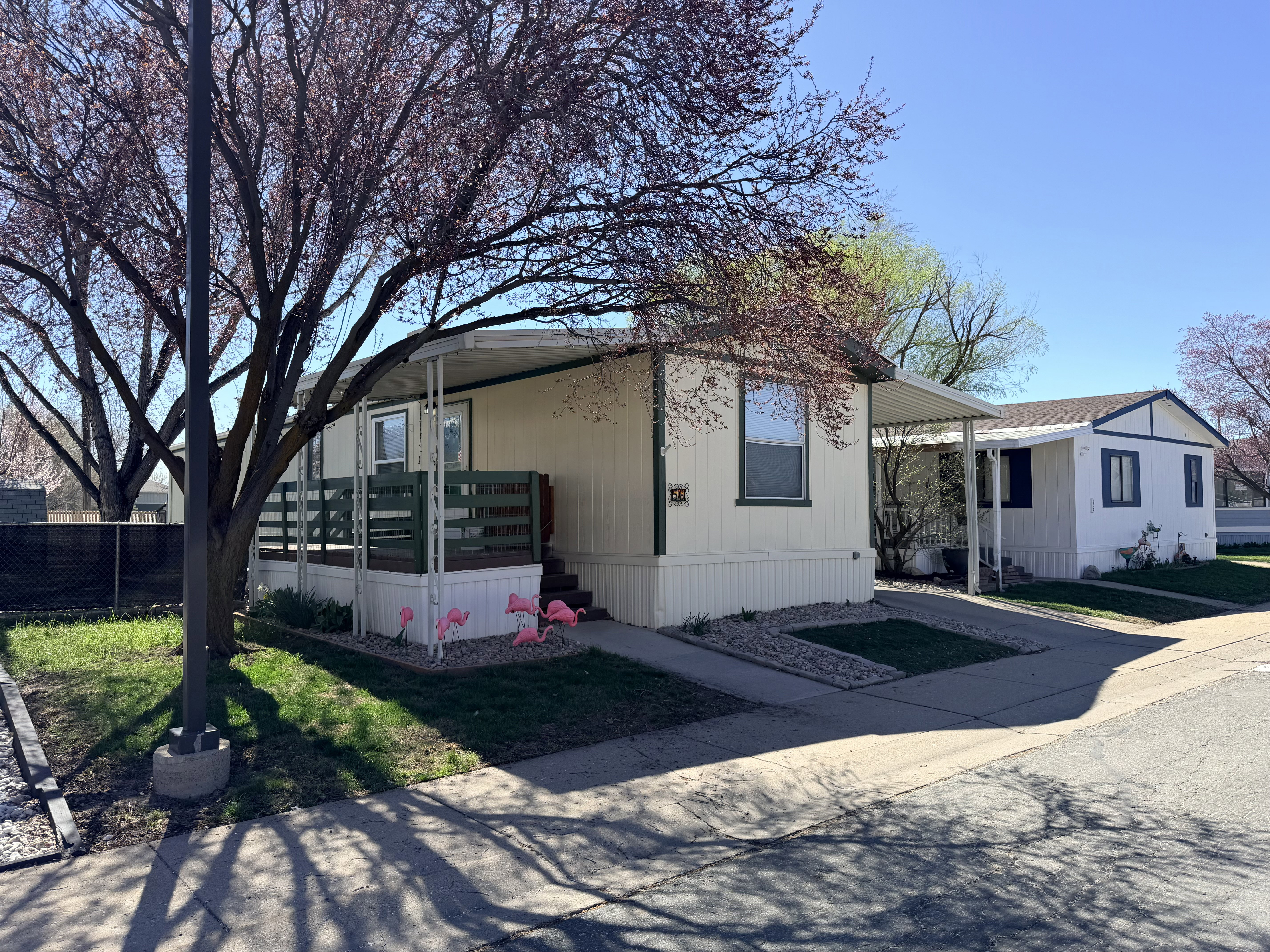 Manufactured / mobile home featuring a carport and concrete driveway