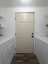 Laundry area with dark wood-type flooring, a textured ceiling, and washing machine and dryer