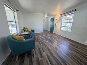 Sitting room featuring dark wood-style floors