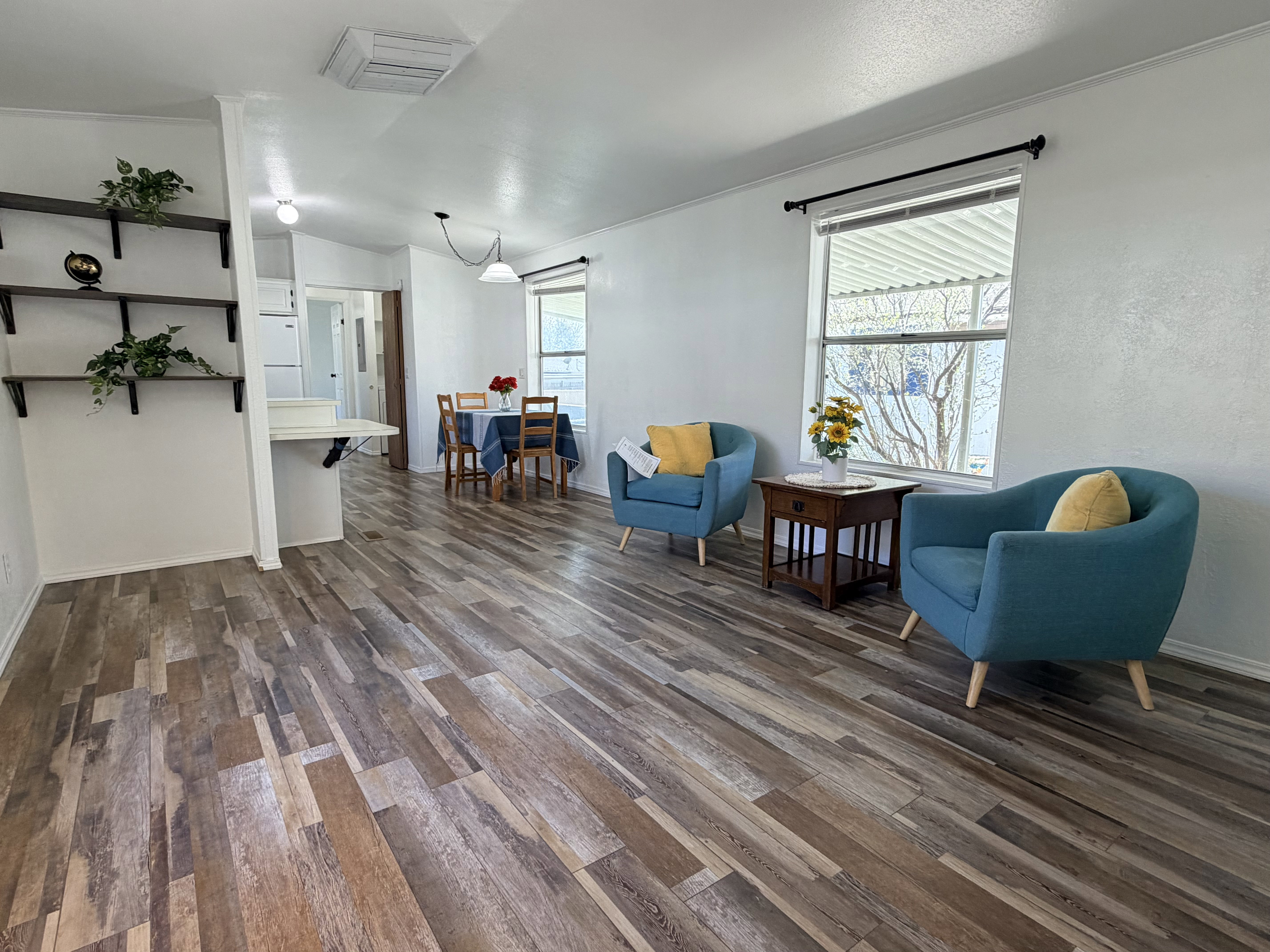 Living area with dark wood finished floors and cooling unit