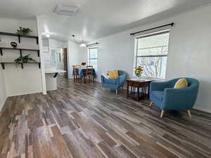 Living area with dark wood finished floors and cooling unit