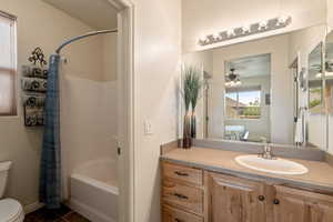 Bathroom with vanity, shower / tub combo, ensuite bathroom, and a ceiling fan
