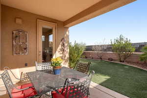 Fenced backyard with a patio area and outdoor dining space