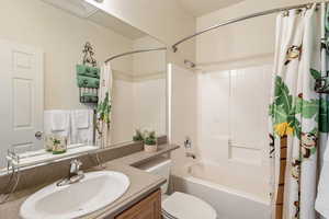 Full bath featuring vanity and shower / bath combo with shower curtain