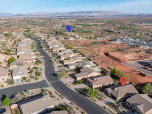 Aerial view of property's location with nearby suburban area and mountains