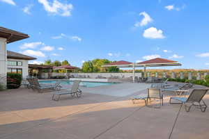 Community pool with a patio