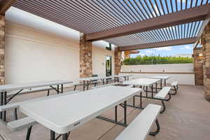 View of patio with outdoor dining area and a pergola