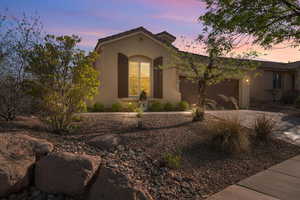 Mediterranean / spanish-style home featuring an attached garage, driveway, and stucco siding