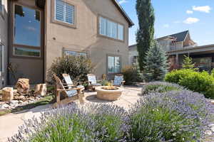 View of lower level patio area featuring an outdoor fire pit and water feature