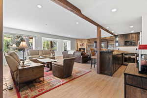 Lower level living area featuring a natural gas fireplace, kitchenette and door leading to the exterior patio