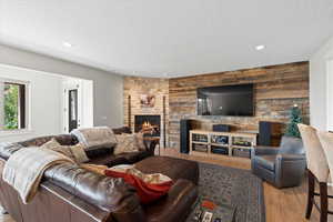 Lower level living area featuring a natural gas fireplace, kitchenette and door leading to the exterior patio