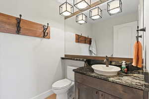 Half bath featuring vanity and toilet