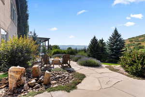 View of lower level patio area featuring an outdoor fire pit and water feature