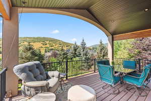 Main level, covered deck featuring outdoor dining space with mountain and valley views