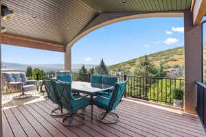 Main level, covered deck featuring outdoor dining space with mountain and valley views