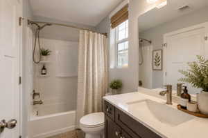 Virtually Staged Bathroom featuring a single vanity with a white countertop and undermount sink, brushed nickel faucet, and dark wood-finish cabinetry