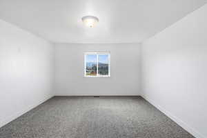 Primary Bedroom Carpeted empty room with baseboards