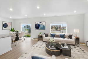 Living area featuring light wood-type flooring and recessed lighting