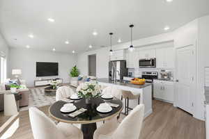 Dining area featuring light wood-style flooring and recessed lighting