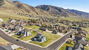 Aerial overview of property's location featuring nearby suburban area and a mountain backdrop