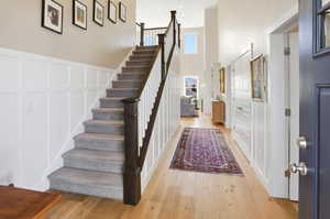 Stairway featuring a high ceiling and hardwood / wood-style floors
