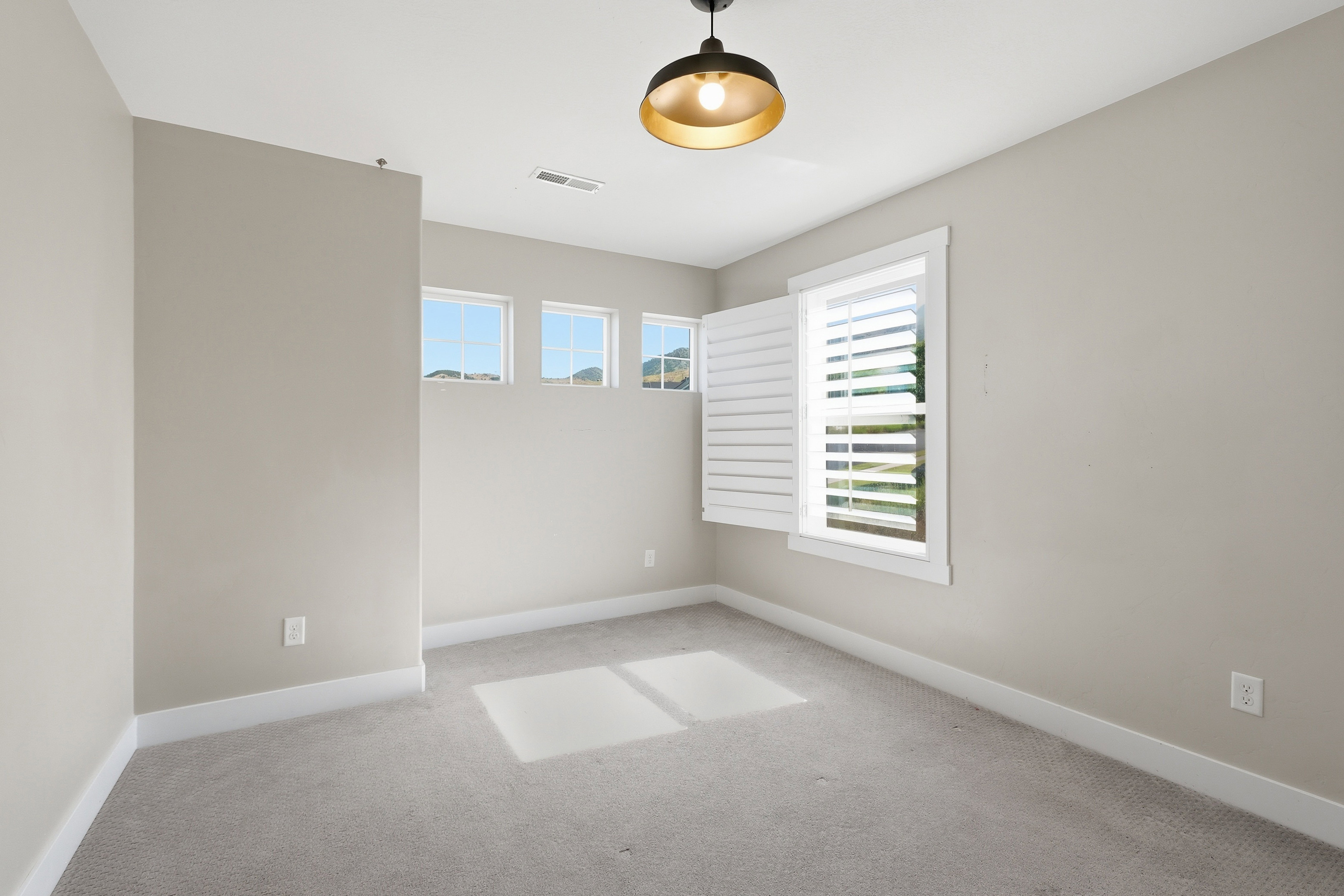 Neutral tone wall paint with white baseboards and trim