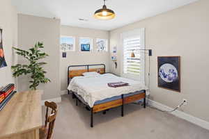 Bedroom featuring baseboards and carpet