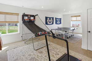 Game room with light colored carpet and recessed lighting