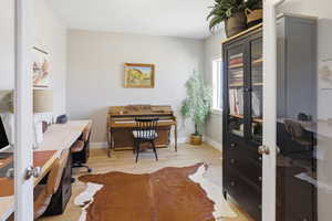 Home office featuring light wood-style floors and french doors