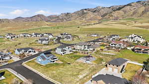 Aerial overview of property's location featuring mountains and nearby suburban area
