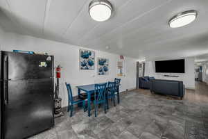 Dining area featuring stone finish flooring and a textured ceiling
