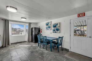 Dining area featuring a textured ceiling and baseboards