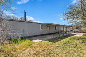 Back of property featuring a yard and a patio area