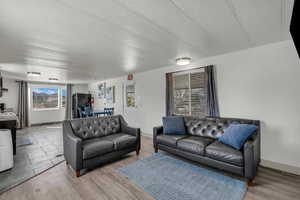Living room with a textured ceiling and wood finished floors