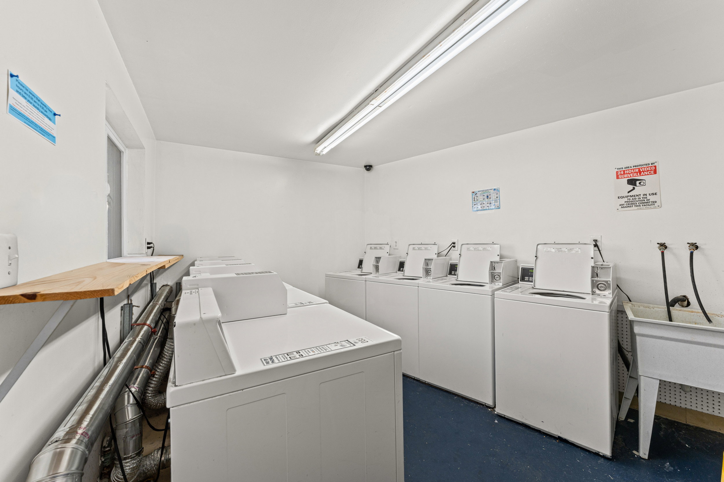 Laundry room featuring separate washer and dryer and a sink