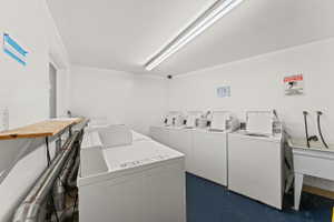 Laundry room featuring separate washer and dryer and a sink