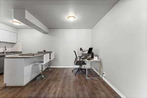 Office featuring dark wood finished floors and baseboards