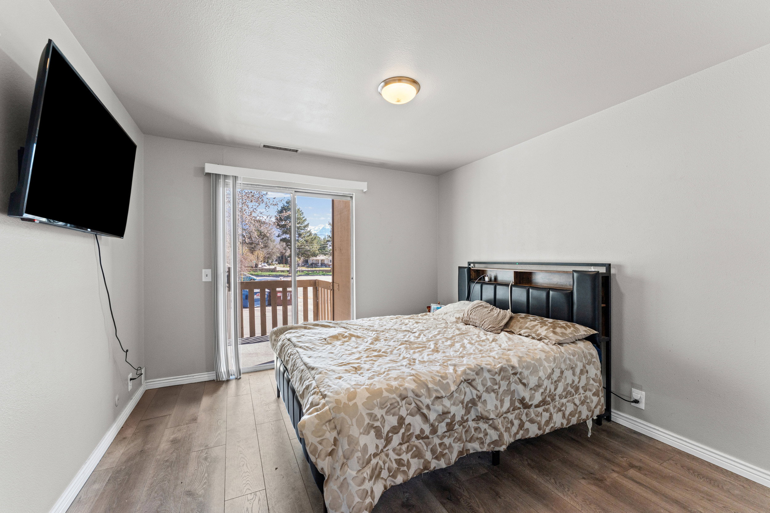 Bedroom featuring hardwood / wood-style flooring and access to exterior