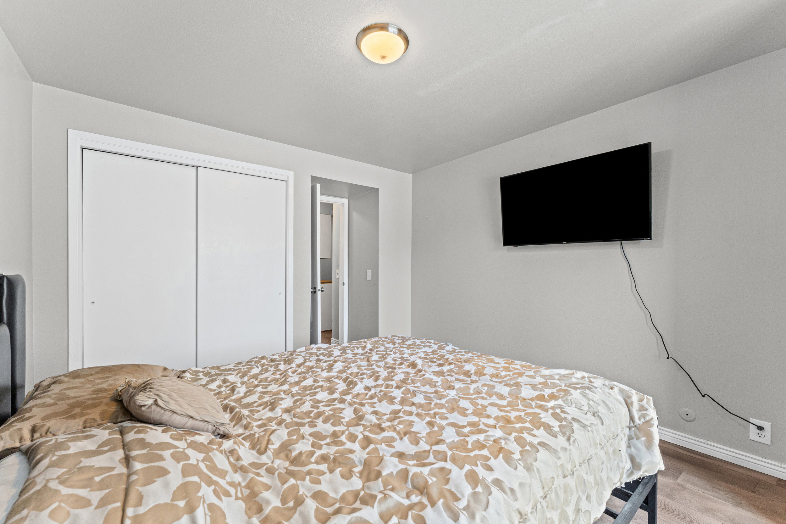 Bedroom featuring light wood-style floors and a closet